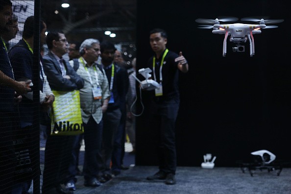 A DJI employee demonstrates flying a drone at CES 2016 at the Las Vegas Convention Center in Las Vegas, Nevada. 