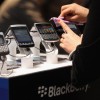 Visitors try out Blackberry smartphones at the Blackberry stand on the first day of the CeBIT 2012 technology trade fair in Hanover, Germany. 
