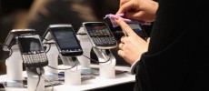 Visitors try out Blackberry smartphones at the Blackberry stand on the first day of the CeBIT 2012 technology trade fair in Hanover, Germany. 