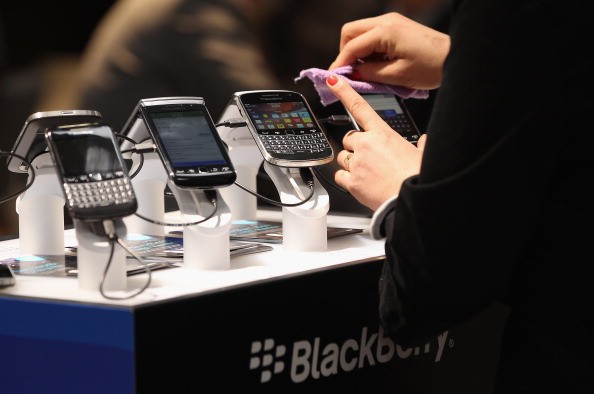 Visitors try out Blackberry smartphones at the Blackberry stand on the first day of the CeBIT 2012 technology trade fair in Hanover, Germany. 