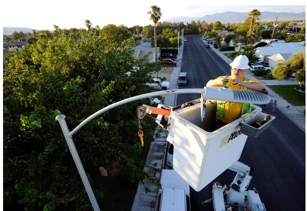 A field electrician replaces a streetlight with new LED fixtures  in Las Vegas, Nevada.