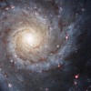 Messier 74, also called NGC 628, is a stunning example of a grand-design spiral galaxy that is viewed by Earth observers nearly face-on.