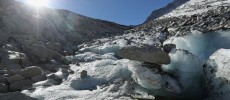 Large chunks of ice stand melting in the sun near the foot of the Hornkees glacier in Austria. 