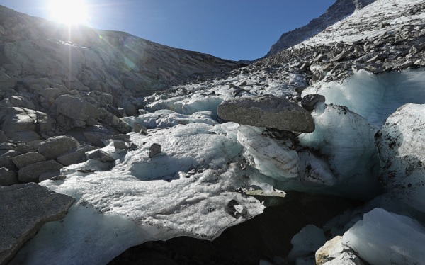 Large chunks of ice stand melting in the sun near the foot of the Hornkees glacier in Austria. 