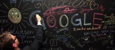 A visitor writes on a chalkboard at the official opening party of the Google offices in Berlin, Germany. 