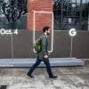 A pedestrian walks by a sign outside an event by Google where they will introduce Google Pixel phone and other Google products in San Francisco, California. 