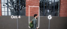 A pedestrian walks by a sign outside an event by Google where they will introduce Google Pixel phone and other Google products in San Francisco, California. 
