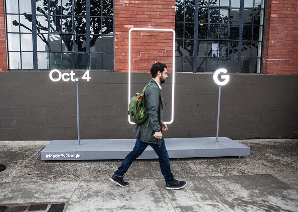 A pedestrian walks by a sign outside an event by Google where they will introduce Google Pixel phone and other Google products in San Francisco, California. 