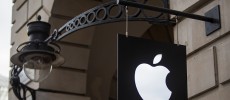  The Apple logo sits on a sign outside company's Covent Garden store in London, England.