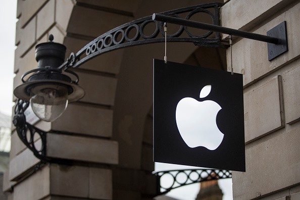  The Apple logo sits on a sign outside company's Covent Garden store in London, England.