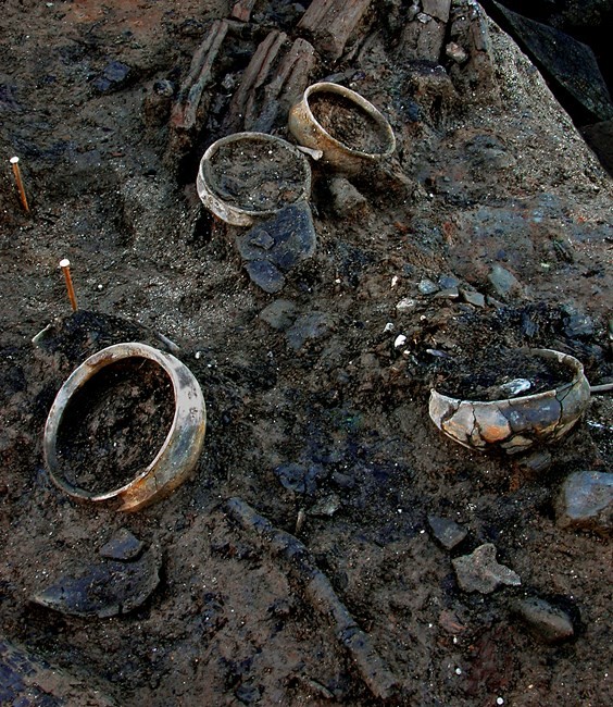 Whole pots, fragments of textiles and other material from the timber dwelling after the structure was destroyed by fire. 
