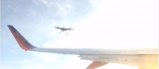 A drone approaching the wing of an airplane.