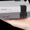 The NES Classic in a hand to highlight the size of the game console. (Nintendo)