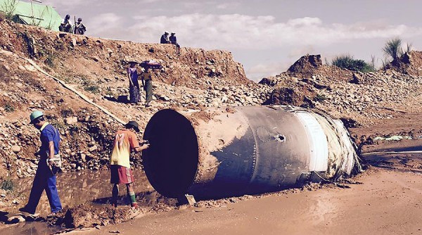 This massive metal cylinder fell from the sky and crashed in a jade mine in Myanmar. (Facebook)